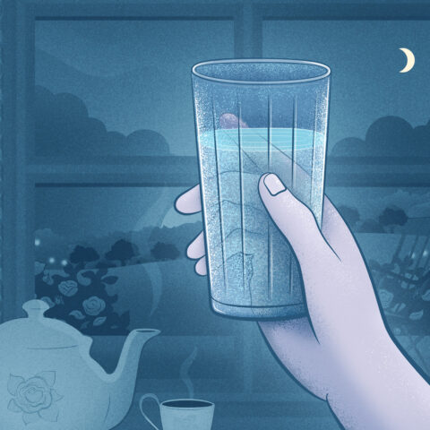 A person holding a glass of water at nighttime